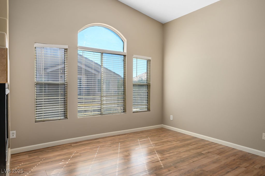 6610 Tumbleweed Ridge Lane, Unit 101 Henderson, NV 89011 - Photo 10 of 24 Empty room featuring wood finished floors and baseboards