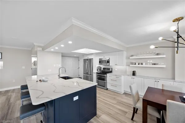 a kitchen with a sink cabinets and wooden floor