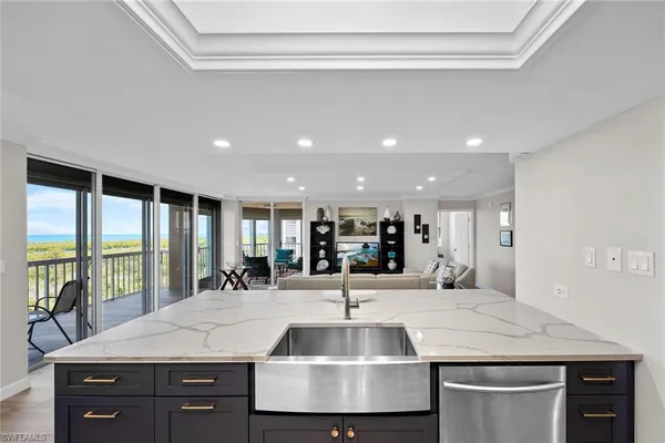 a view of kitchen island a sink and living room
