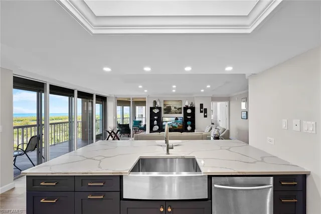 a view of kitchen island a sink and living room