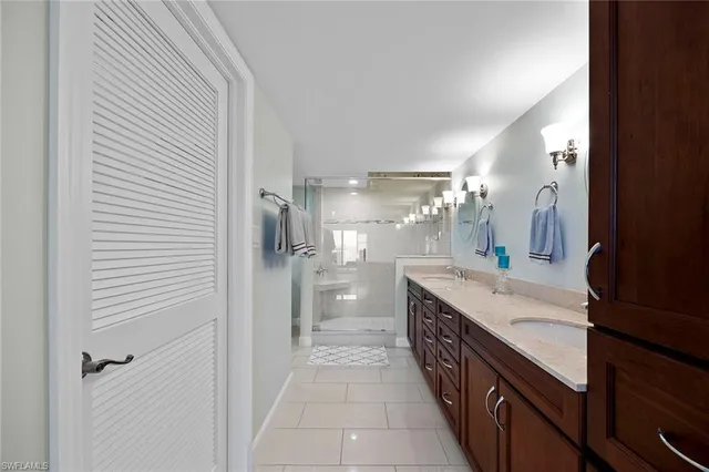 a bathroom with a double vanity sink and mirror