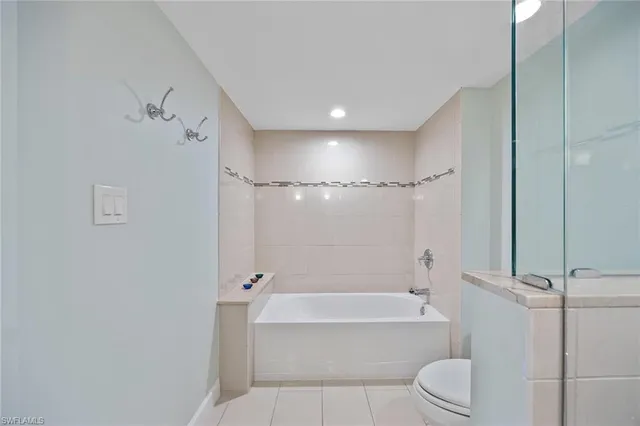 a bathroom with a toilet a sink and bathtub