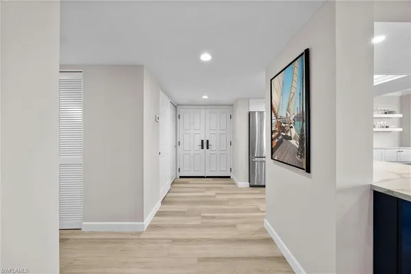 a view of a hallway with wooden floor and staircase