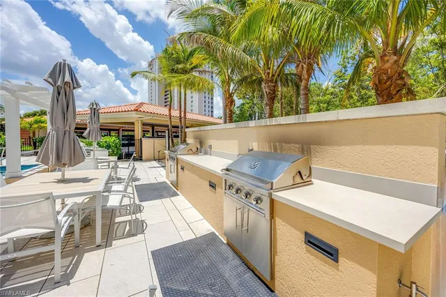 a view of a patio with swimming pool and a chairs