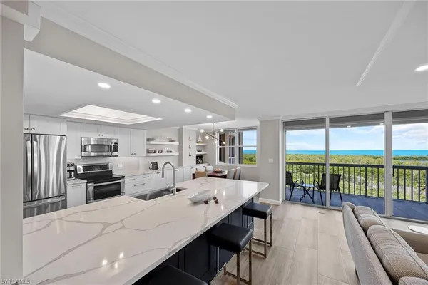 a large kitchen with a large window and stainless steel appliances