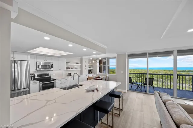 a large kitchen with a large window and stainless steel appliances
