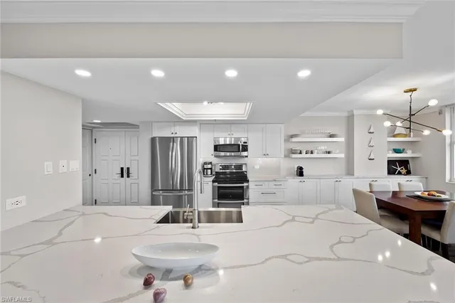 a large kitchen with kitchen island a sink stainless steel appliances and cabinets