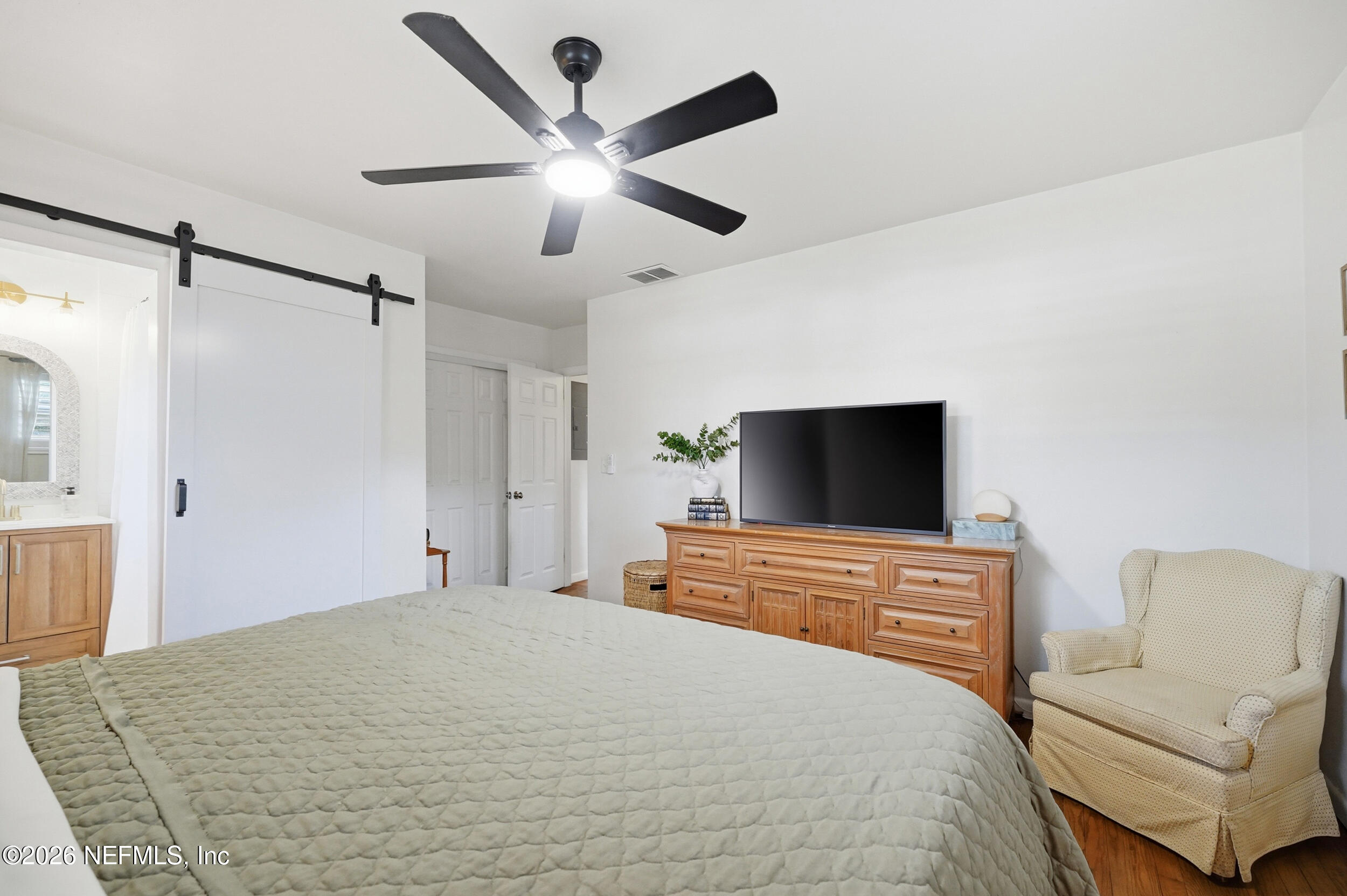 10524 Beverly Nalle Road Jacksonville, FL 32225 - Photo 19 of 28 a bedroom with a bed and a flat screen tv