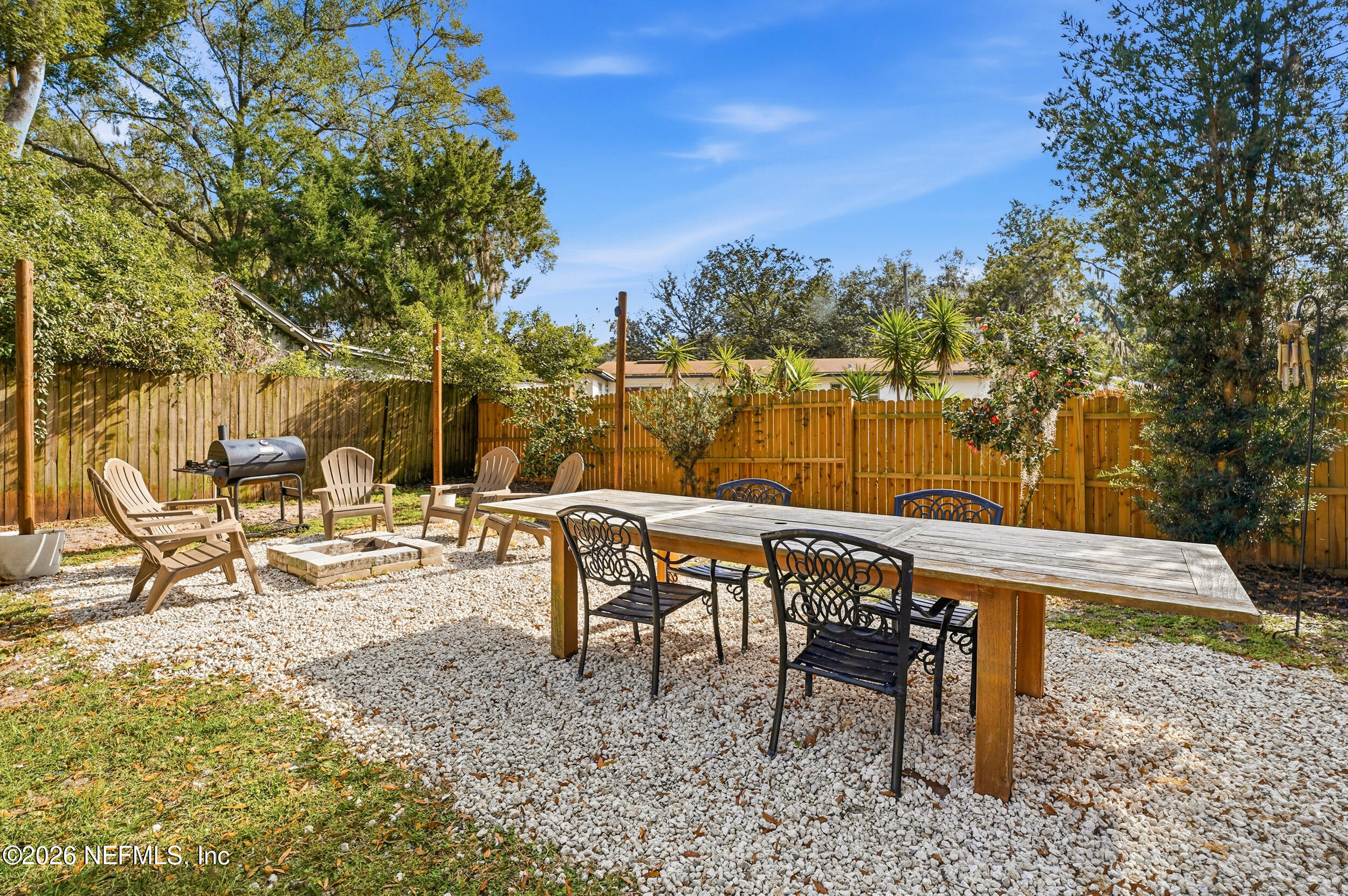 10524 Beverly Nalle Road Jacksonville, FL 32225 - Photo 26 of 28 a view of a lake with a table and chairs