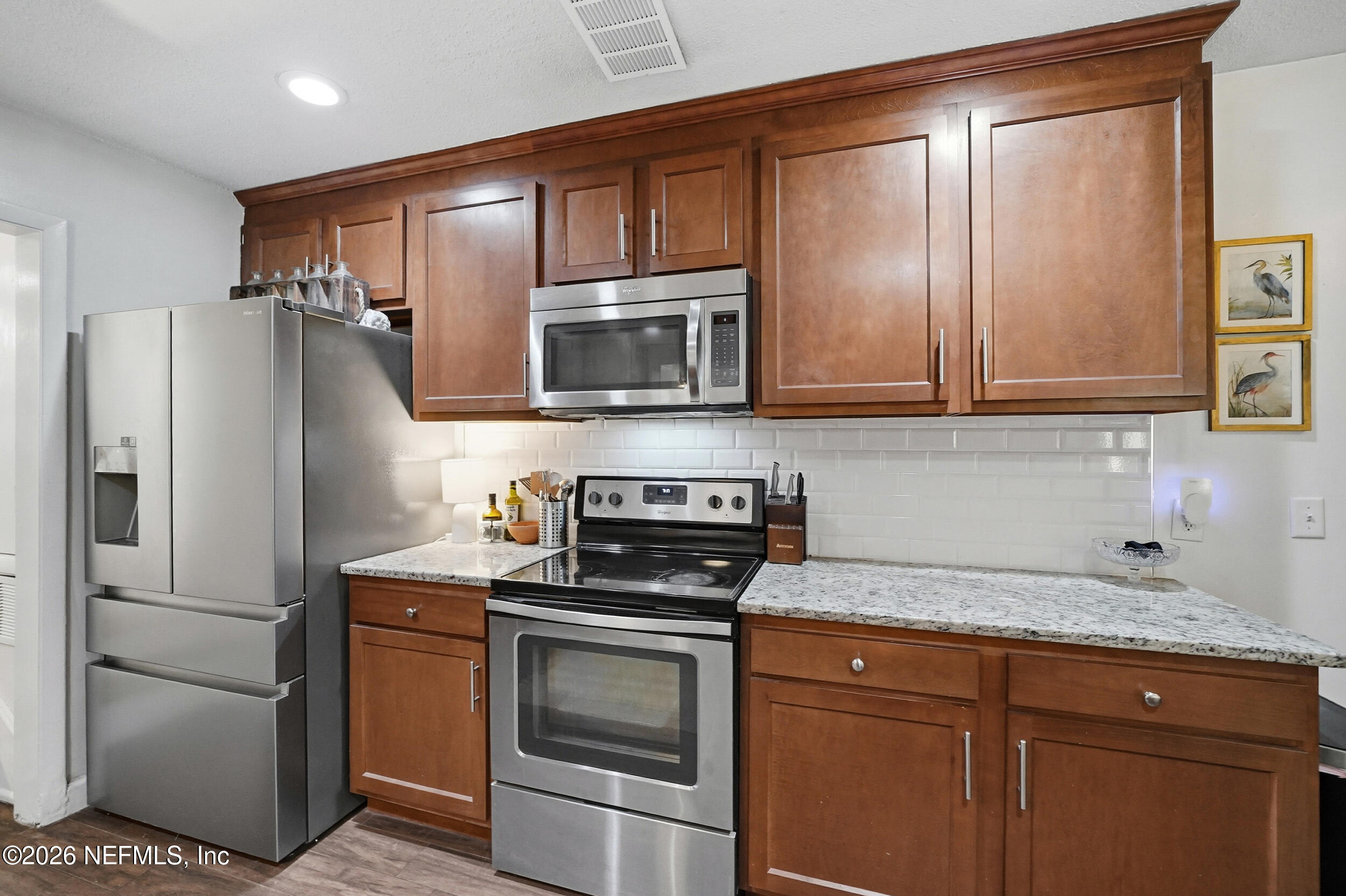 10524 Beverly Nalle Road Jacksonville, FL 32225 - Photo 9 of 28 a kitchen with a refrigerator stove and microwave