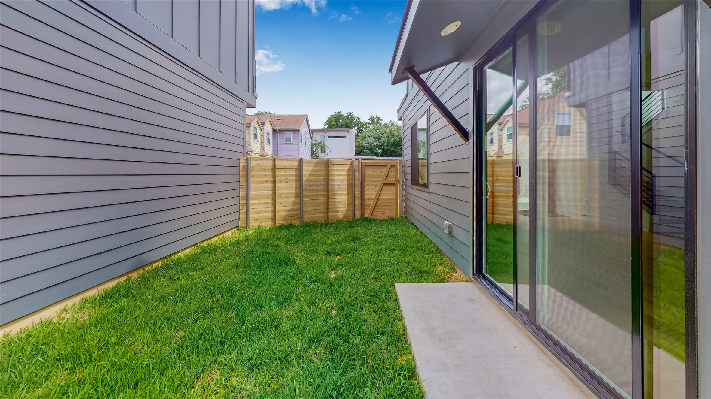 4424 Hank Avenue, Unit 2 Austin, TX 78745 - Photo 10 of 11 A well-maintained fenced yard offers a private outdoor retreat with a spacious sliding glass door entrance.