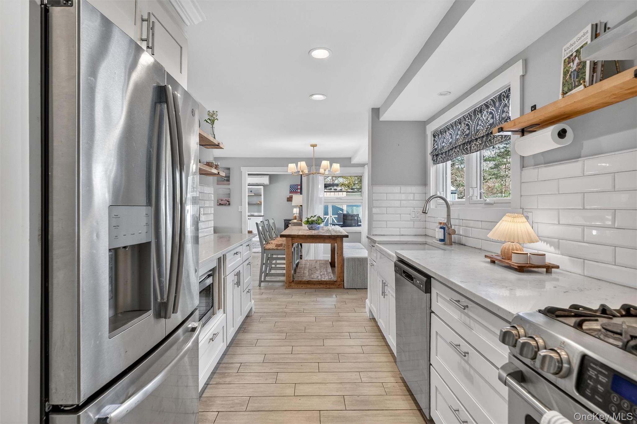 18 Lambert Lane New Rochelle, NY 10804 - Photo 14 of 47 Kitchen featuring open shelves, white cabinets, appliances with stainless steel finishes, light stone countertops, and recessed lighting