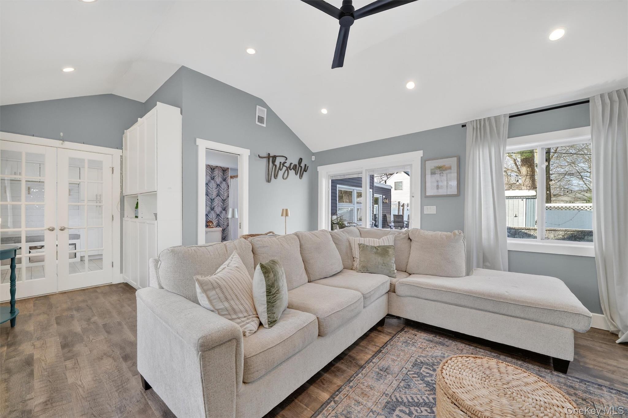 18 Lambert Lane New Rochelle, NY 10804 - Photo 20 of 47 Living room with recessed lighting, a ceiling fan, french doors, dark wood-style flooring, and vaulted ceiling
