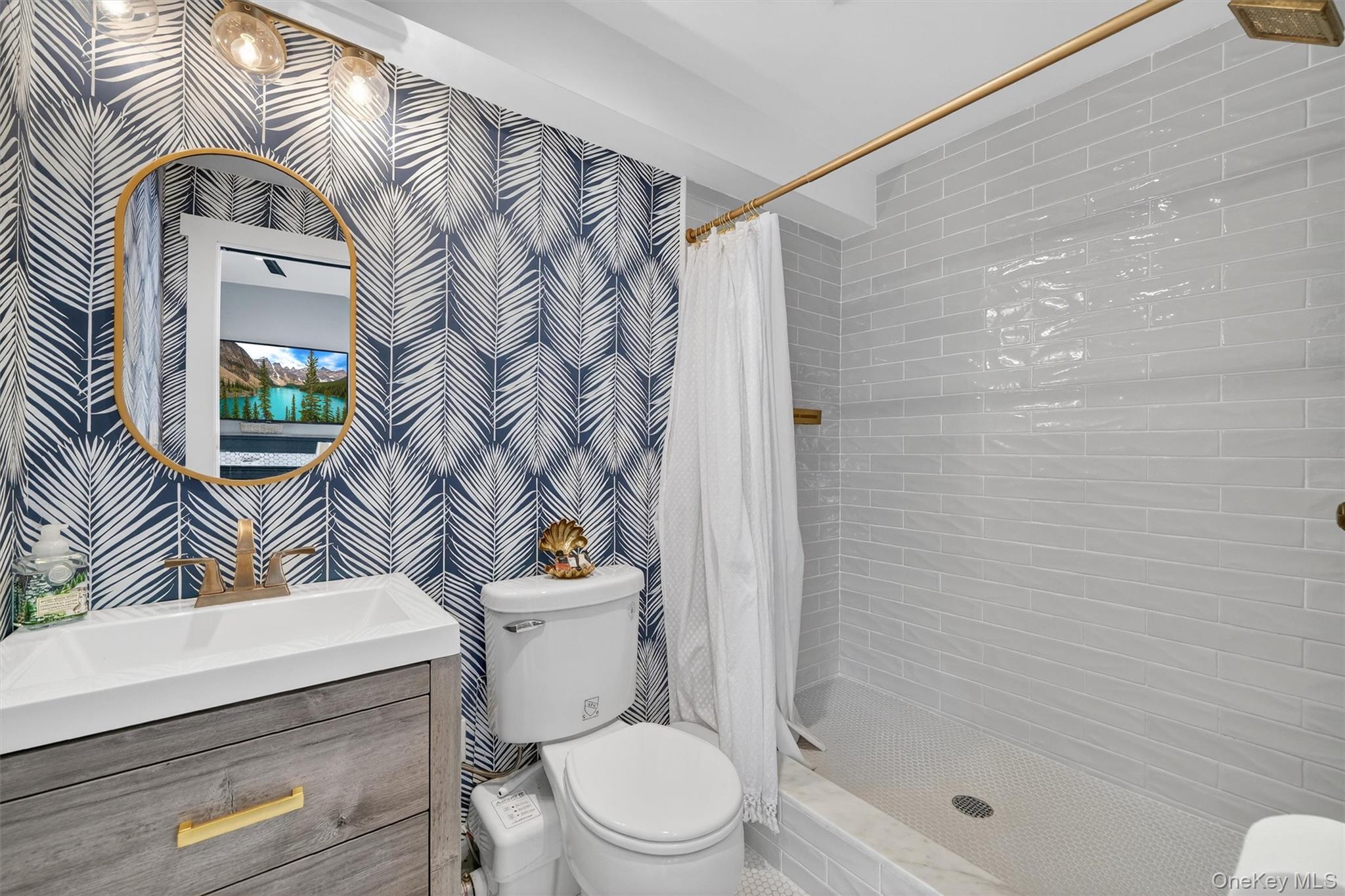 18 Lambert Lane New Rochelle, NY 10804 - Photo 23 of 47 Bathroom featuring a stall shower, vanity, and wallpapered walls