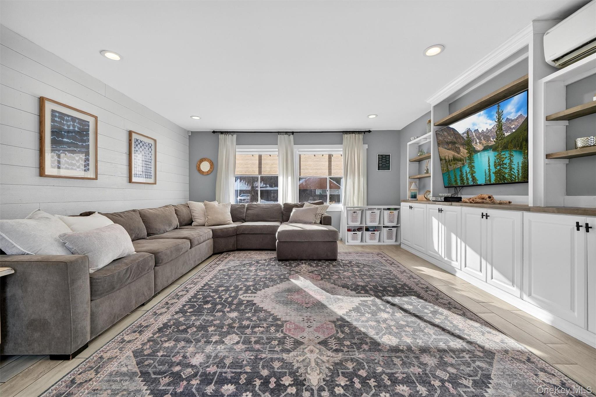 18 Lambert Lane New Rochelle, NY 10804 - Photo 24 of 47 Living room with a wall mounted air conditioner, wood walls, and recessed lighting