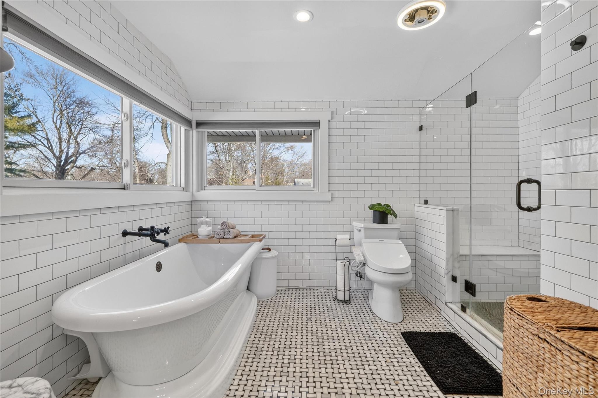 18 Lambert Lane New Rochelle, NY 10804 - Photo 32 of 47 Full bathroom featuring tile walls, a freestanding tub, a shower stall, tile patterned floors, and recessed lighting