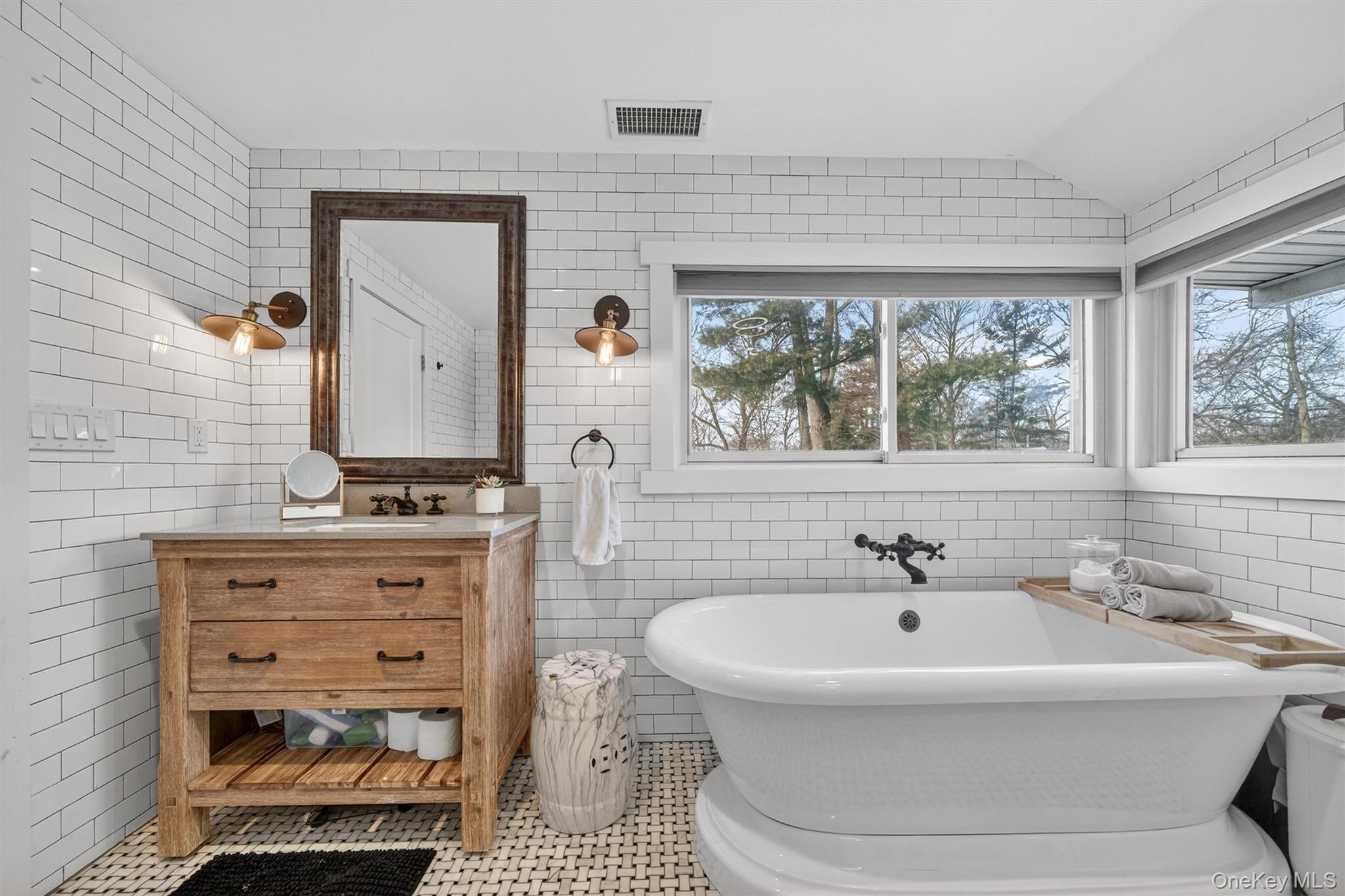 18 Lambert Lane New Rochelle, NY 10804 - Photo 34 of 47 Bathroom with tile walls, vanity, tile patterned flooring, a freestanding bath, and lofted ceiling