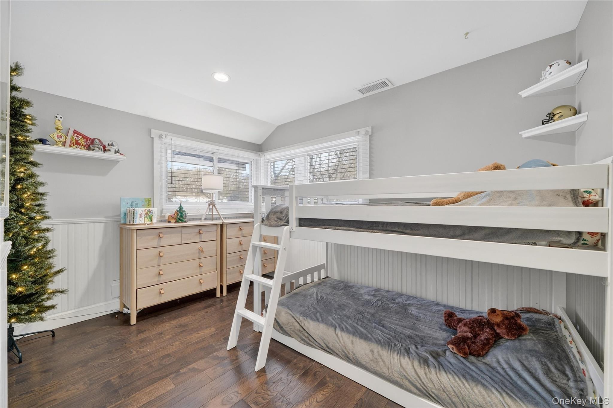 18 Lambert Lane New Rochelle, NY 10804 - Photo 36 of 47 Bedroom featuring wainscoting, lofted ceiling, and dark wood-type flooring