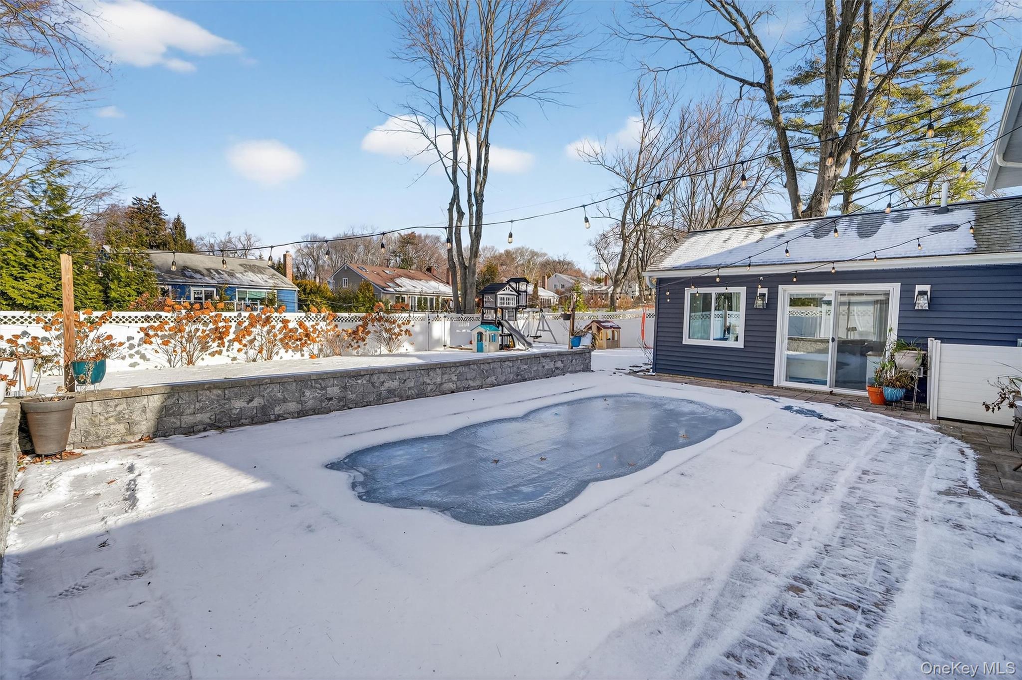 18 Lambert Lane New Rochelle, NY 10804 - Photo 41 of 47 Snow covered pool with a patio area, a fenced backyard, and a playground
