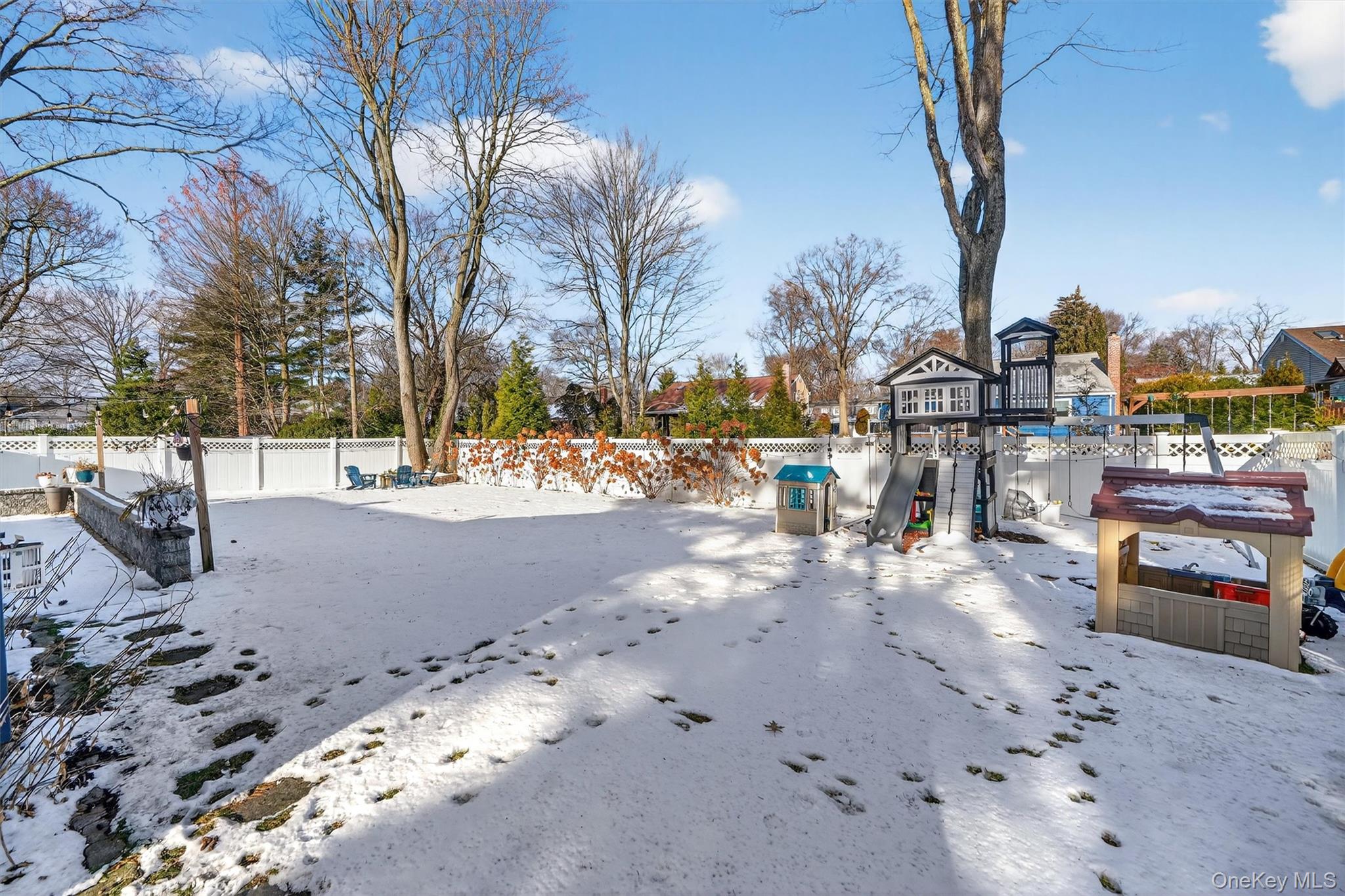 18 Lambert Lane New Rochelle, NY 10804 - Photo 45 of 47 Yard covered in snow with a fenced backyard and a playground