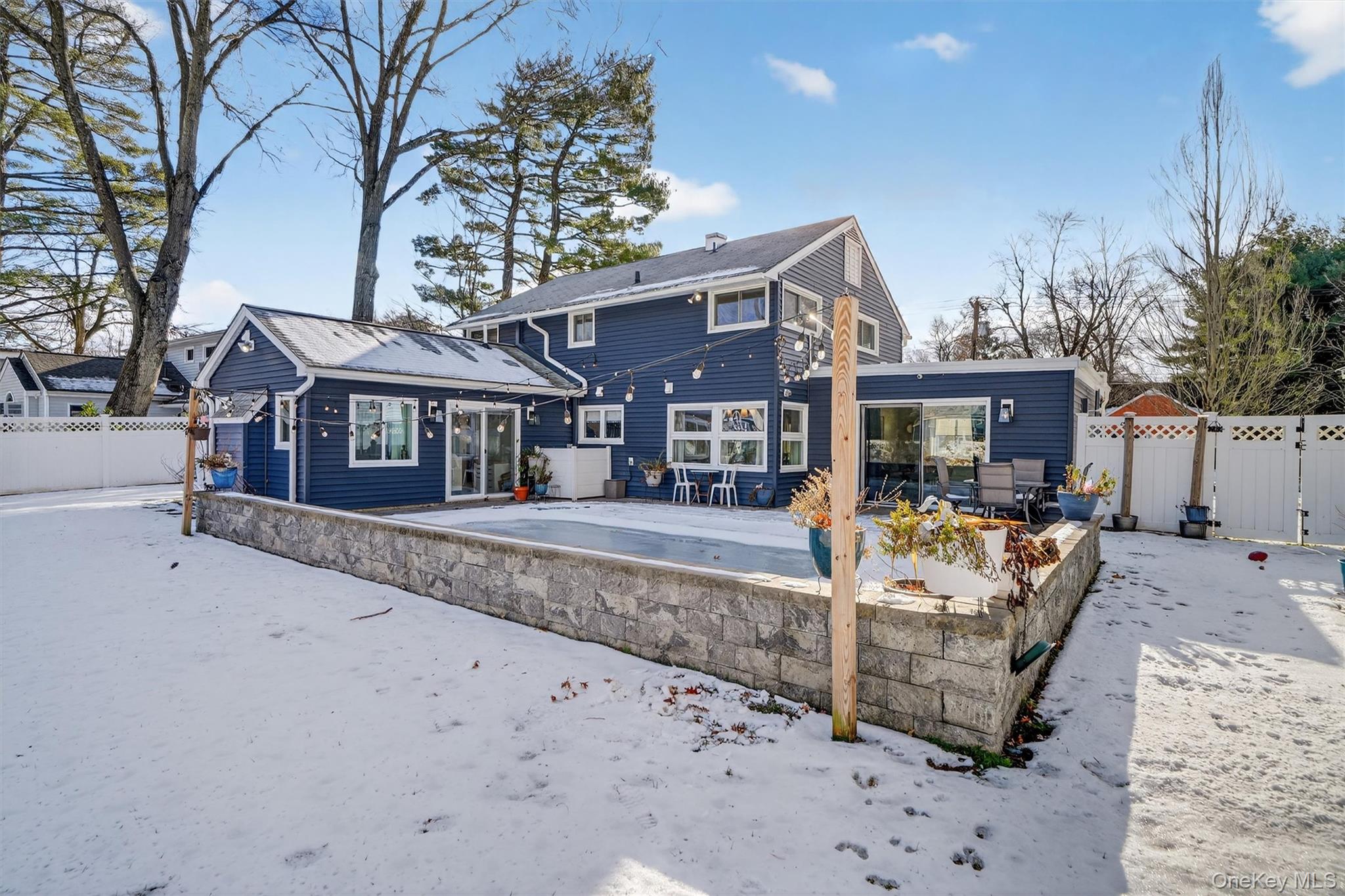 18 Lambert Lane New Rochelle, NY 10804 - Photo 46 of 47 Snow covered rear of property with a fenced backyard and a patio area