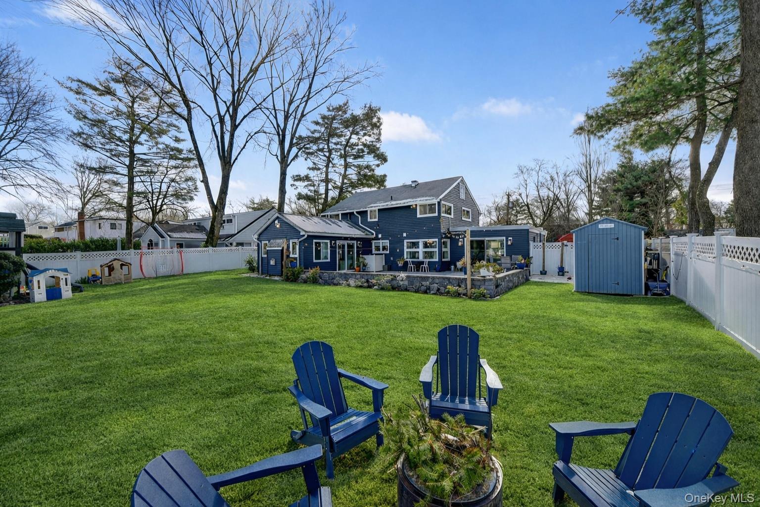 18 Lambert Lane New Rochelle, NY 10804 - Photo 47 of 47 Back of house featuring a fenced backyard, a storage shed, and a patio area