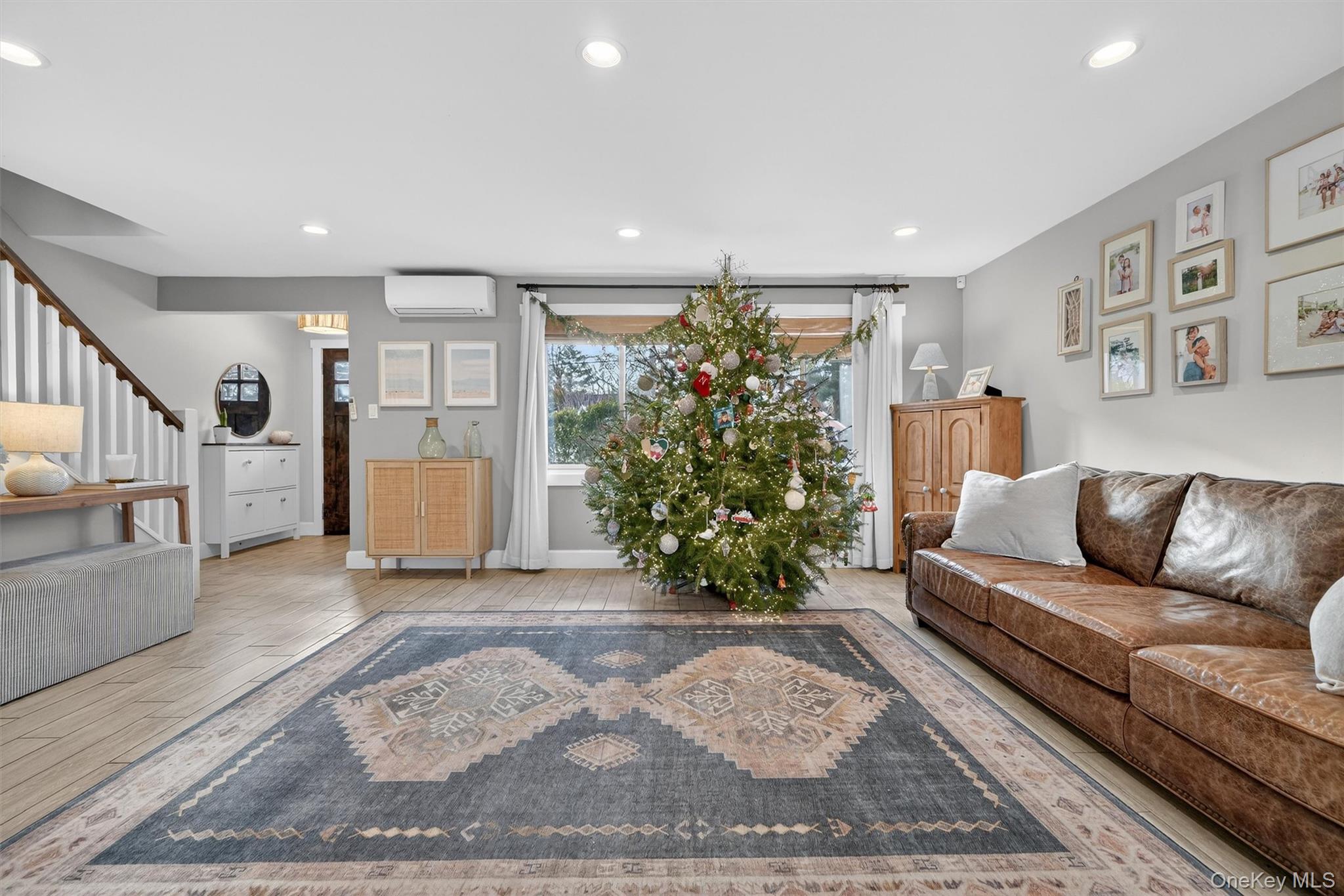 18 Lambert Lane New Rochelle, NY 10804 - Photo 7 of 47 Living room featuring light wood tiles floors, stairway, recessed lighting, and a wall unit AC
