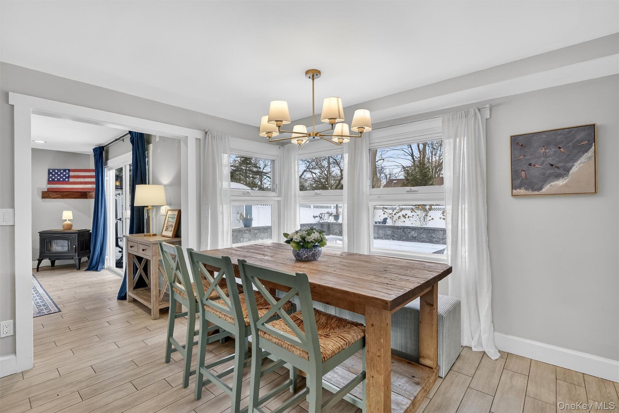 18 Lambert Lane New Rochelle, NY 10804 - Photo 8 of 47 Dining area featuring wood tiled floors, plenty of natural light, and a chandelier