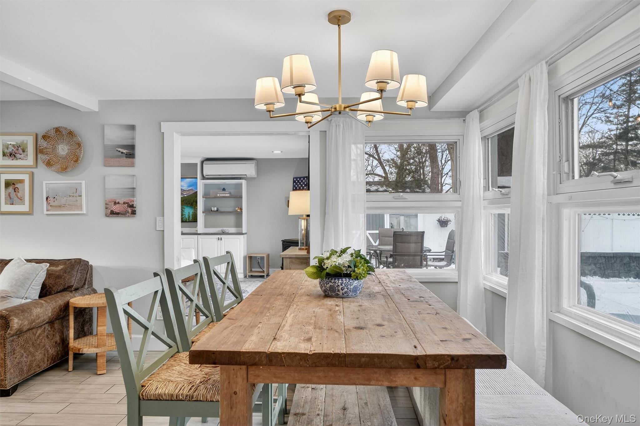 18 Lambert Lane New Rochelle, NY 10804 - Photo 9 of 47 Dining space featuring wood tiled floors, a chandelier, and a wall unit AC
