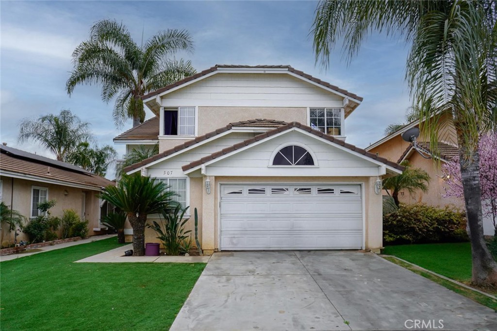 507 Lassa Way Perris, CA 92571 - Photo 1 of 36 a front view of a house with a garden and palm trees