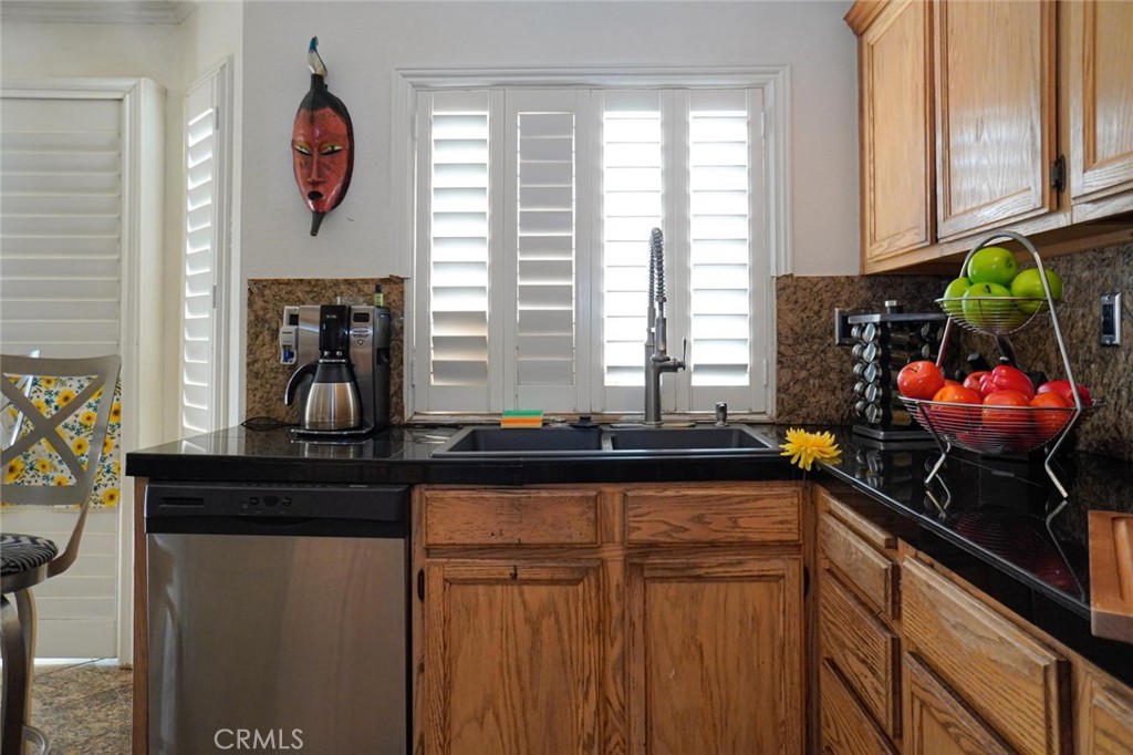 507 Lassa Way Perris, CA 92571 - Photo 17 of 36 a kitchen with a sink and cabinets
