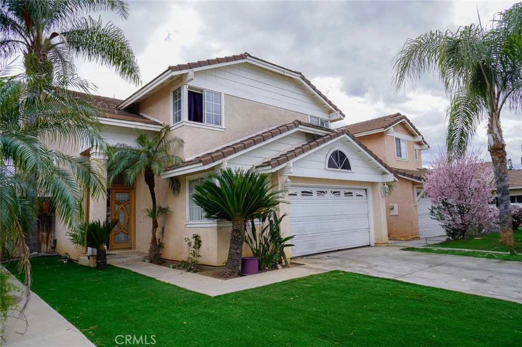 507 Lassa Way Perris, CA 92571 - Photo 2 of 36 a front view of house with yard and green space