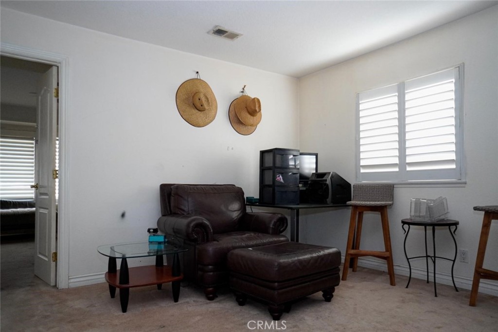 507 Lassa Way Perris, CA 92571 - Photo 25 of 36 a living room with furniture a window and a lamp
