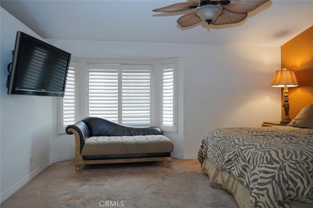 507 Lassa Way Perris, CA 92571 - Photo 28 of 36 a bedroom with a bed couch tv and window