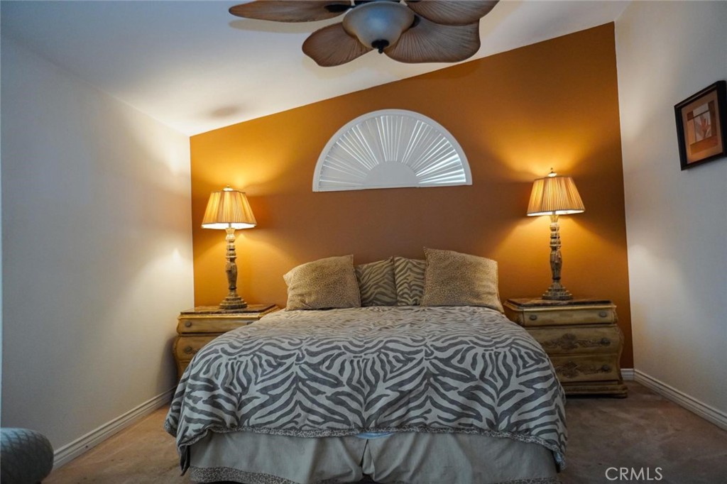 507 Lassa Way Perris, CA 92571 - Photo 31 of 36 a bedroom with a bed and lamp with the wall