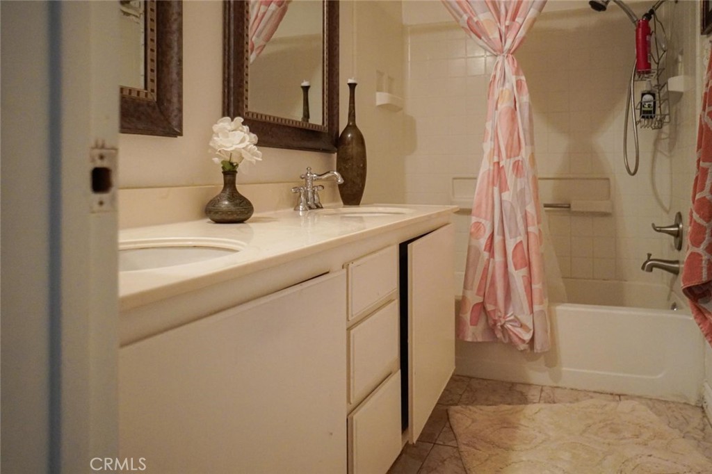 507 Lassa Way Perris, CA 92571 - Photo 36 of 36 a bathroom with a sink and mirror with bathtub