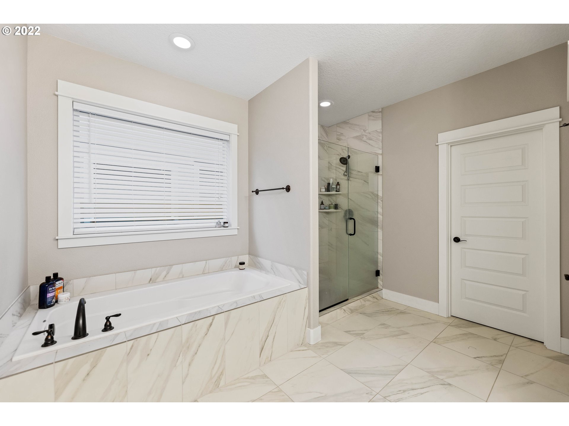4616 South 16th Drive Ridgefield, WA 98642 - Photo 15 of 28 a bathroom with a tub sink and mirror