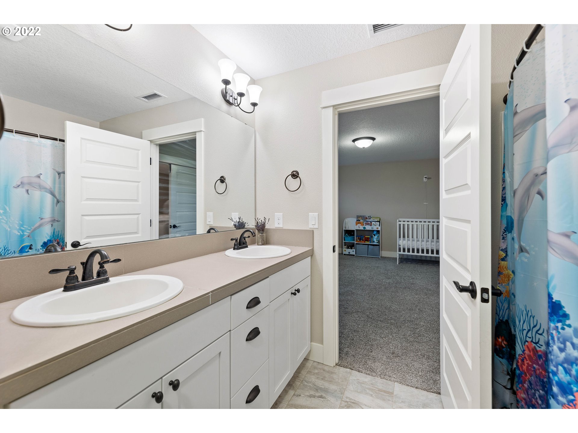 4616 South 16th Drive Ridgefield, WA 98642 - Photo 19 of 28 a bathroom with a sink double vanity granite tub shower and a mirror