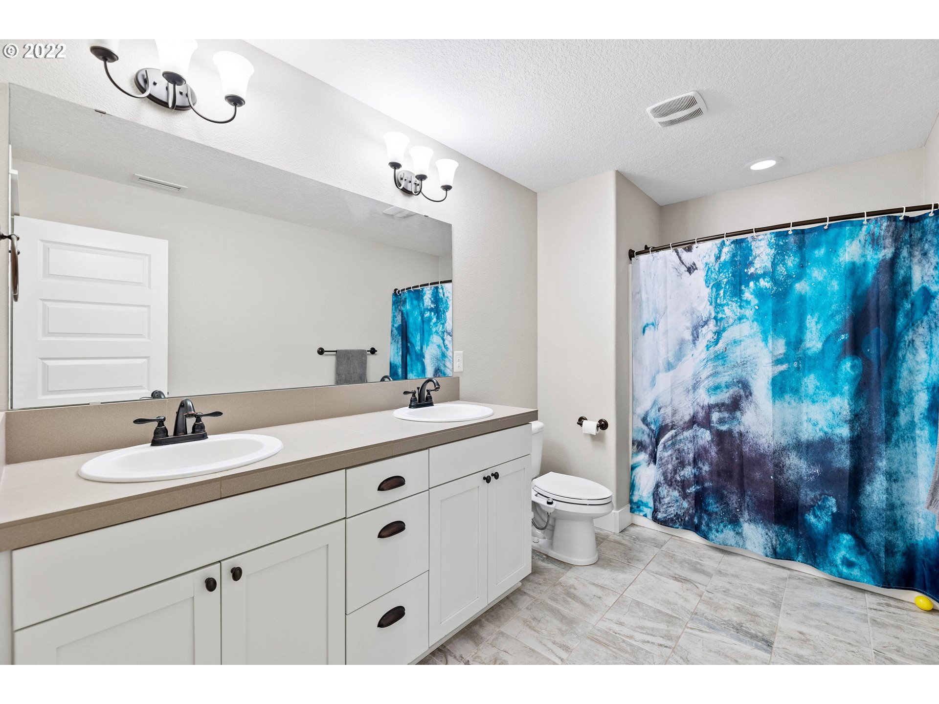 4616 South 16th Drive Ridgefield, WA 98642 - Photo 22 of 28 a bathroom with a double vanity sink mirror and toilet