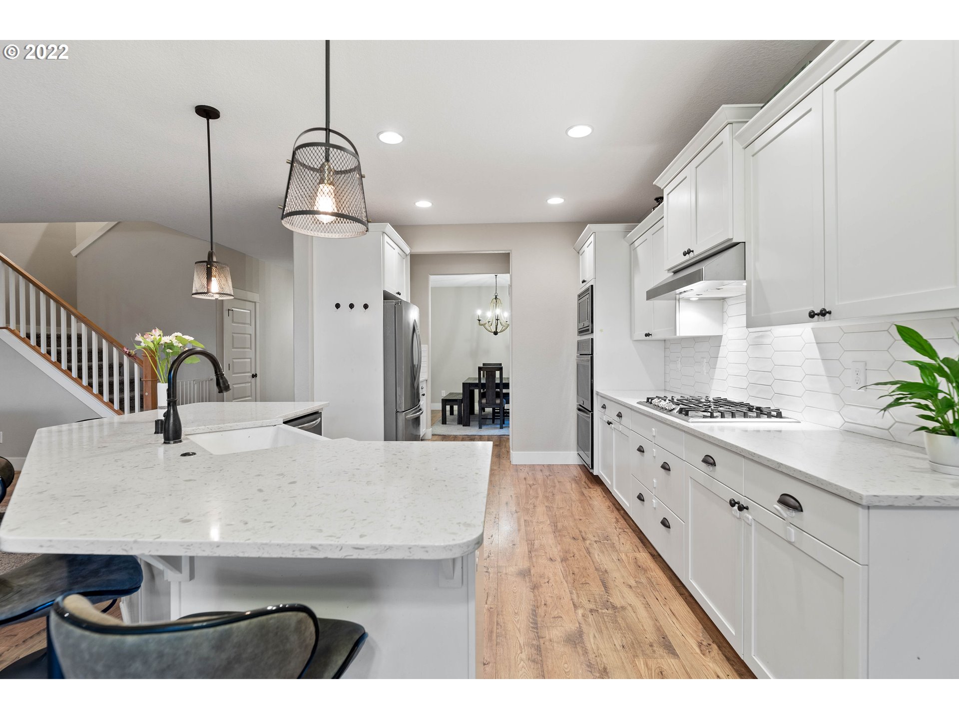 4616 South 16th Drive Ridgefield, WA 98642 - Photo 5 of 28 a kitchen with kitchen island a stove a sink a center island and living room view