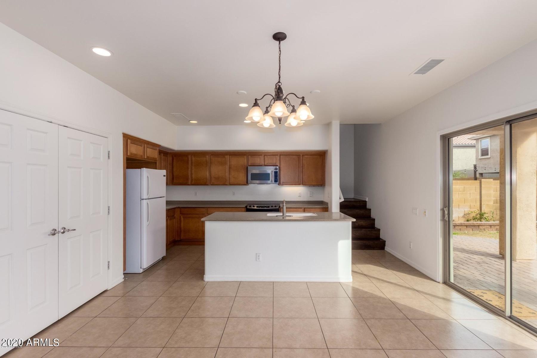 2023 West Davis Road Phoenix, AZ 85023 - Photo 3 of 16 a kitchen with a refrigerator a stove and a sink
