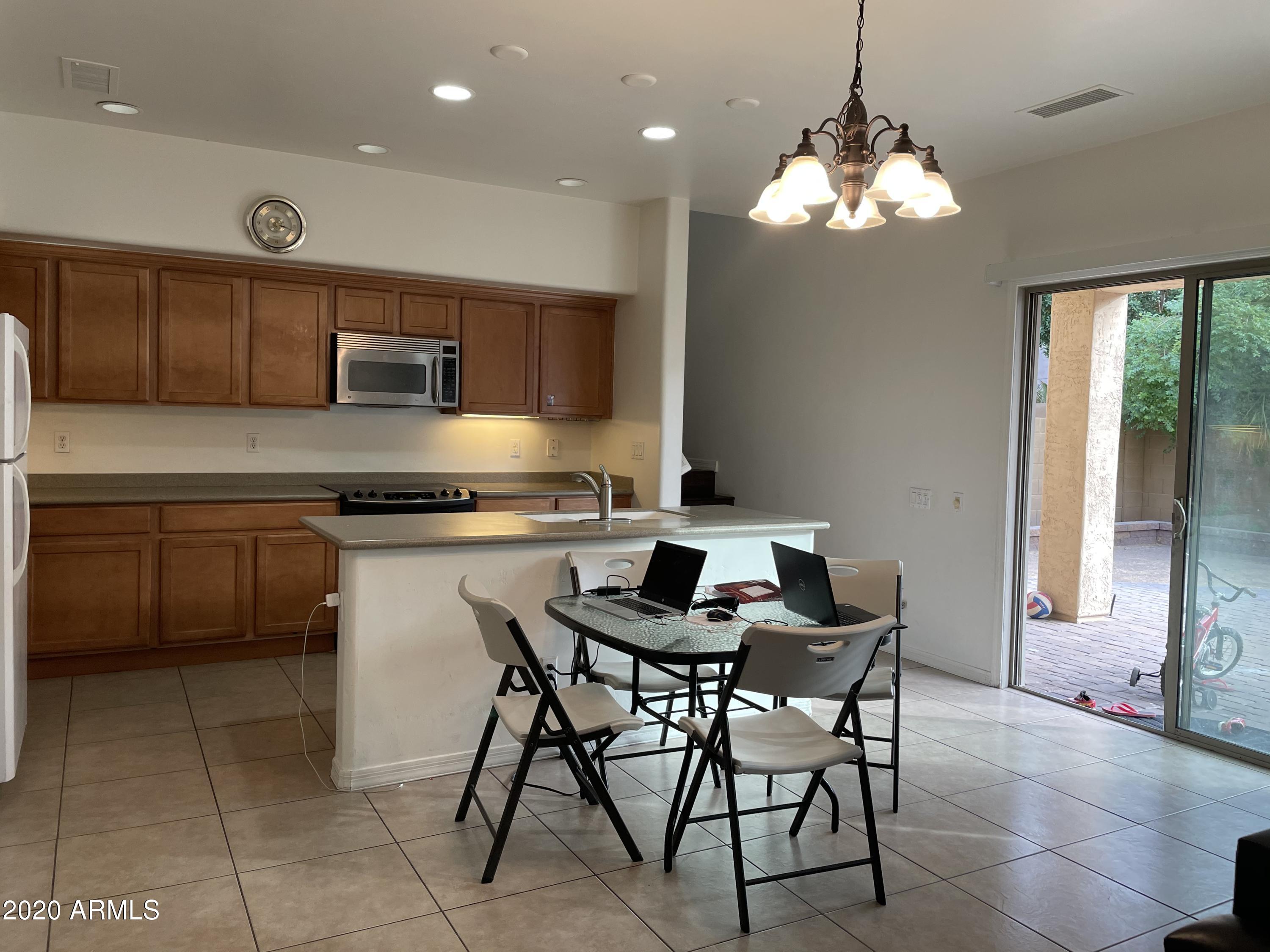 2023 West Davis Road Phoenix, AZ 85023 - Photo 4 of 16 a kitchen with kitchen island granite countertop a sink counter top space appliances and a window