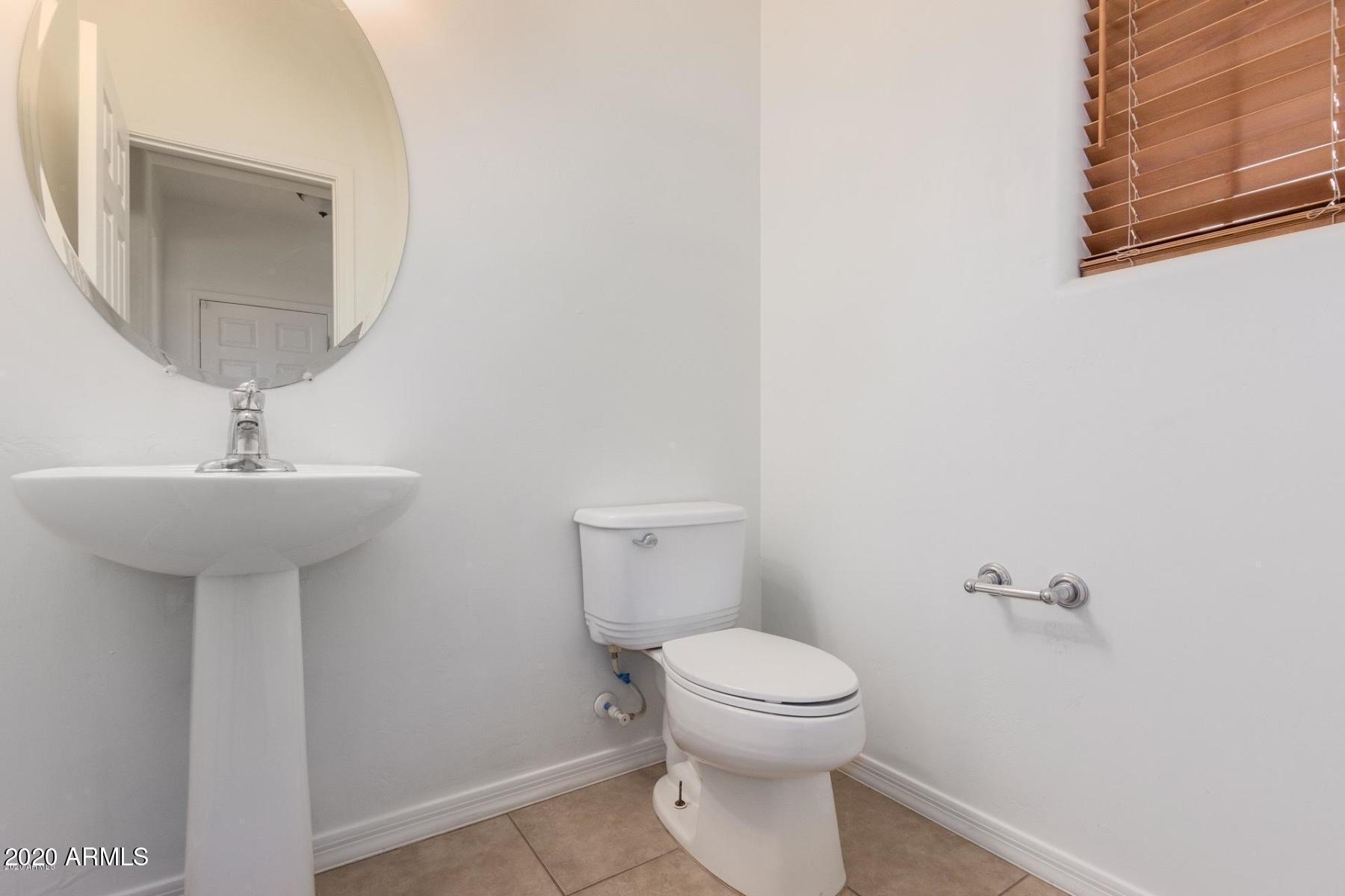 2023 West Davis Road Phoenix, AZ 85023 - Photo 6 of 16 a bathroom with a toilet a sink and mirror