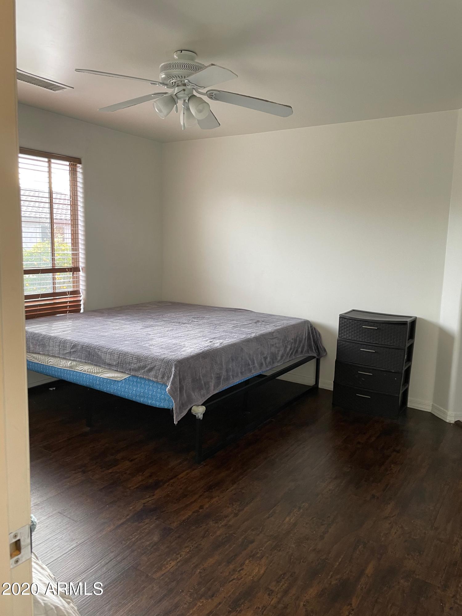 2023 West Davis Road Phoenix, AZ 85023 - Photo 9 of 16 a bedroom with a bed and a table in it