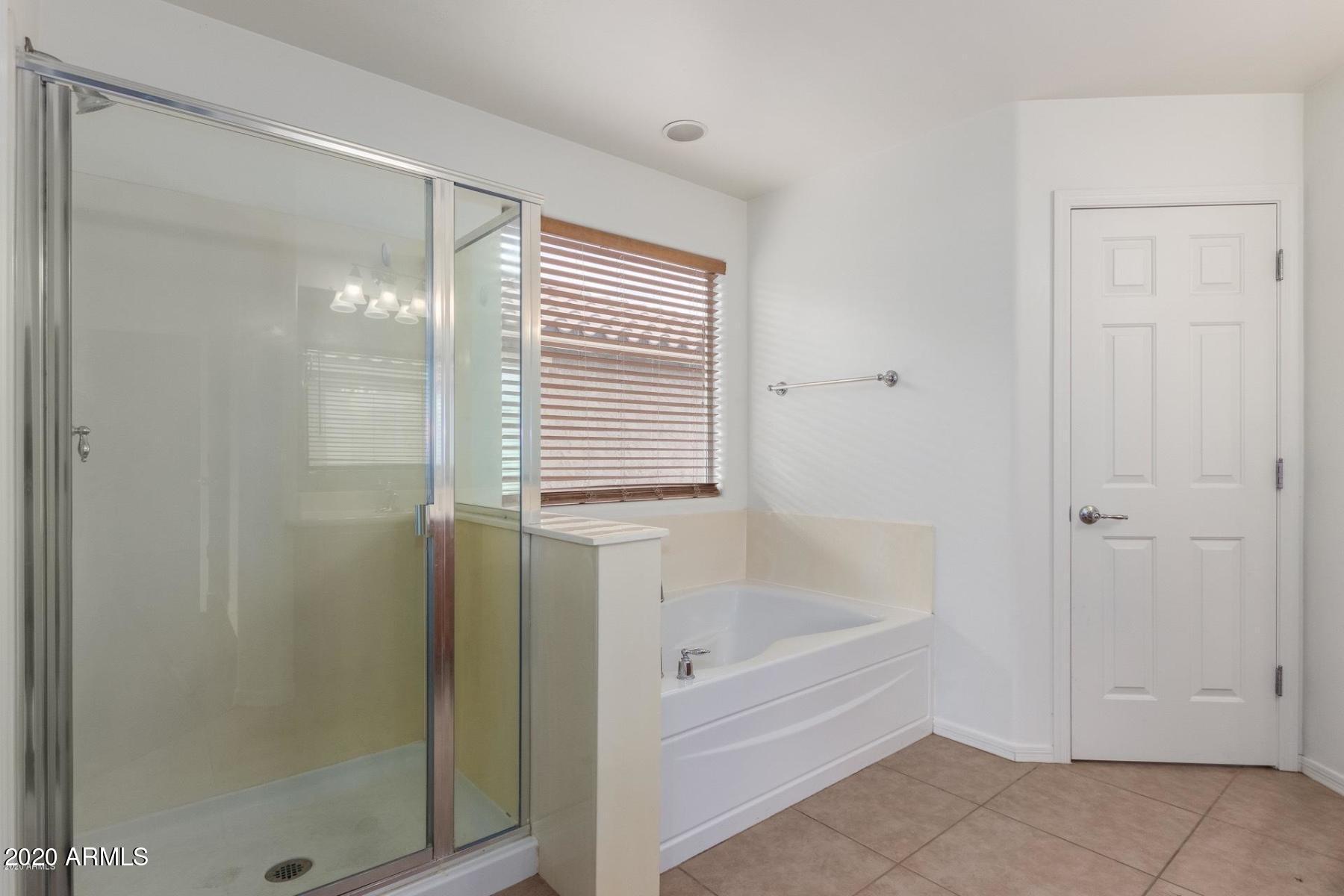 2023 West Davis Road Phoenix, AZ 85023 - Photo 10 of 16 a bathroom with a bathtub and shower