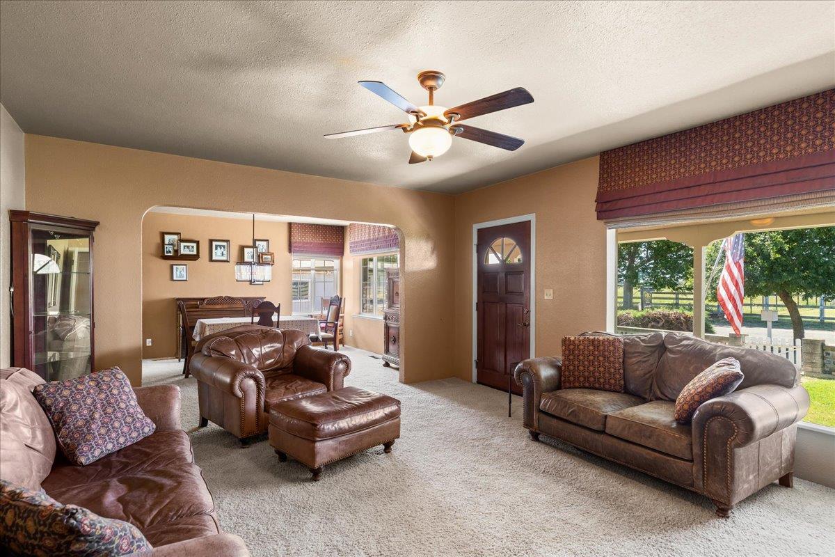 4701 Lone Tree Road Valley Home, CA 95361 - Photo 13 of 59 a living room with furniture and a large window