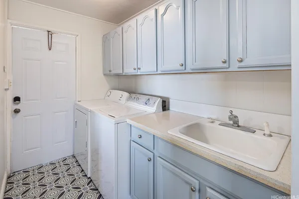 a utility room with sink dryer and washer