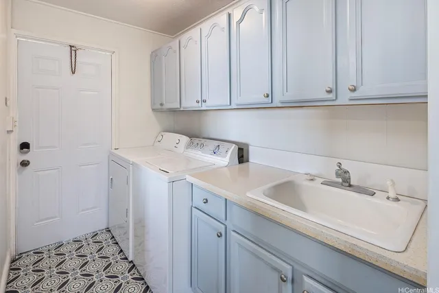 a utility room with sink dryer and washer