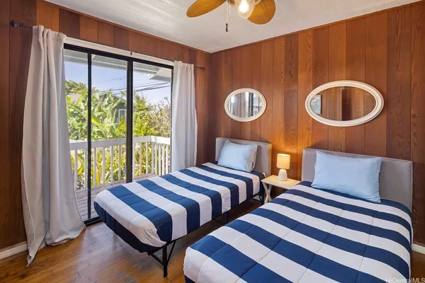 a bedroom with two beds and a window