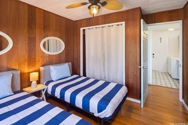 a bedroom with a bed and painting on the wall